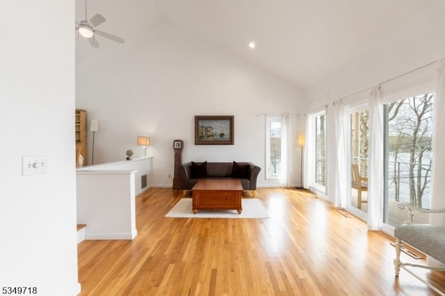 living area featuring high vaulted ceiling, wood finished floors, baseboards, visible vents, and recessed lighting