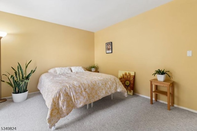 bedroom featuring carpet floors and baseboards