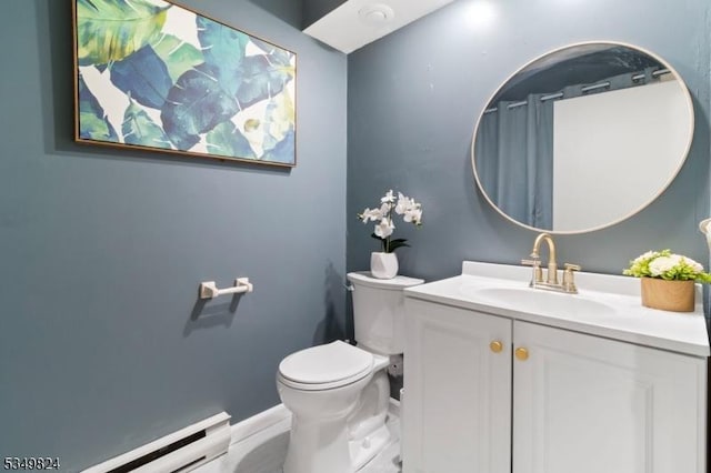bathroom with baseboards, baseboard heating, vanity, and toilet