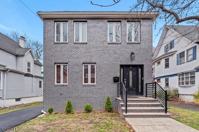 view of front of home featuring brick siding