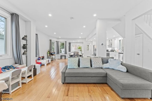 living room featuring light wood-type flooring and recessed lighting