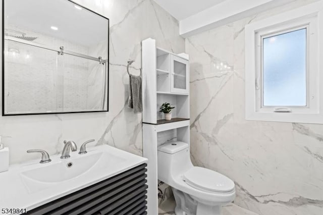 bathroom with tile walls, toilet, and vanity