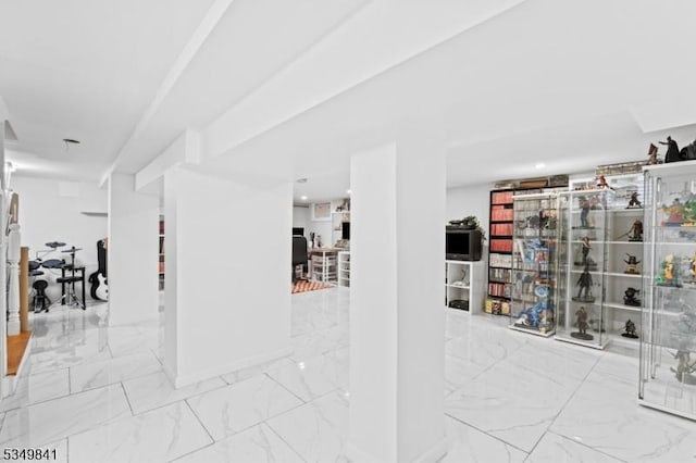 corridor featuring marble finish floor
