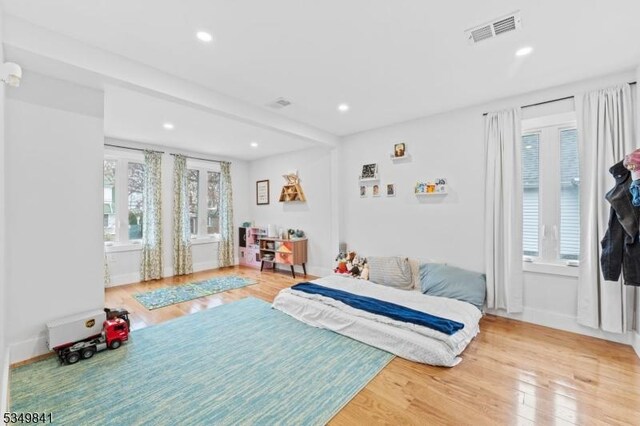 bedroom with visible vents, recessed lighting, and wood finished floors