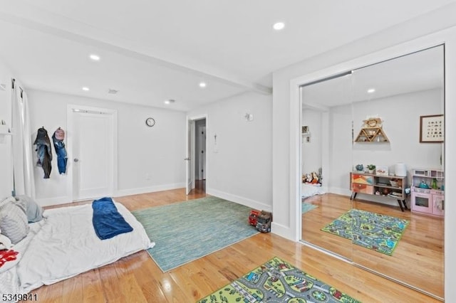 bedroom with wood finished floors, baseboards, and recessed lighting