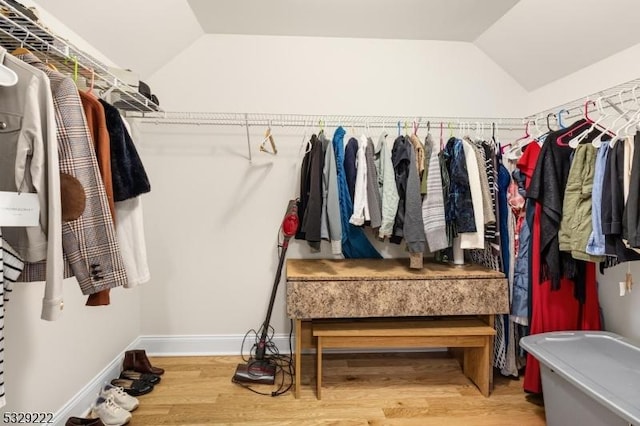 spacious closet featuring wood finished floors and vaulted ceiling