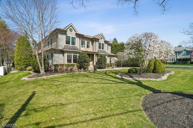 view of front of house with fence and a front lawn