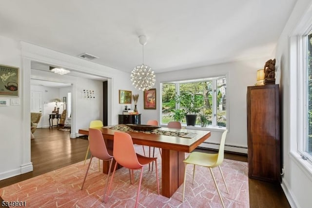 dining room featuring visible vents, an inviting chandelier, wood finished floors, baseboards, and baseboard heating