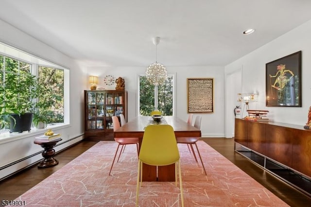 dining space with an inviting chandelier, recessed lighting, wood finished floors, and baseboard heating