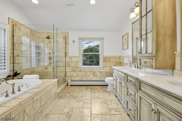 bathroom featuring double vanity, a bath, a stall shower, a sink, and a baseboard heating unit
