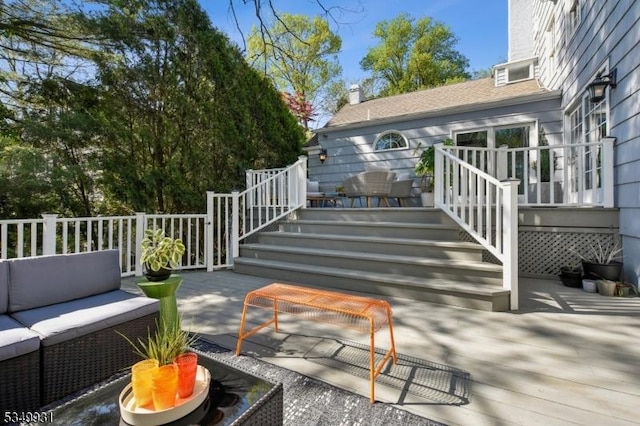 wooden deck featuring stairway, a patio area, and an outdoor hangout area