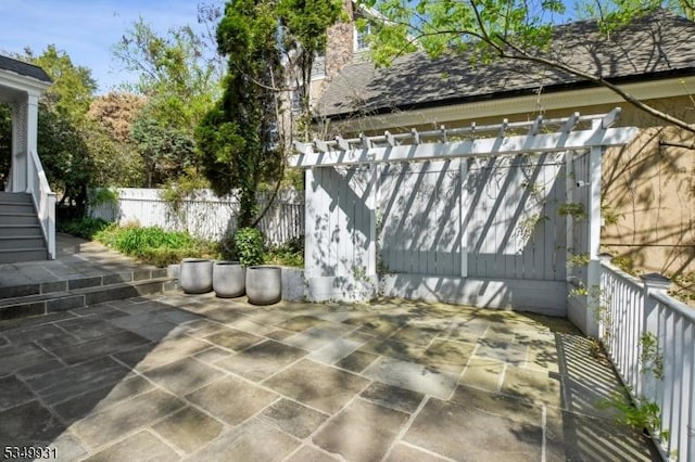 view of patio / terrace with fence and stairs