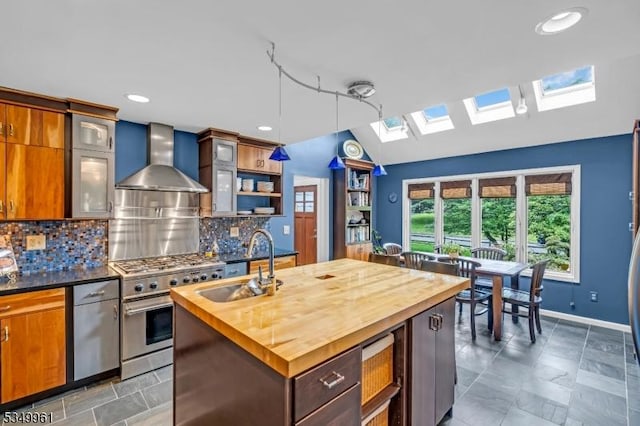 1056 Buxton Rd, Bridgewater Twp, NJ 08807 - kitchen with butcher block countertops, a skylight, wall chimney exhaust hood, a sink, and high end range