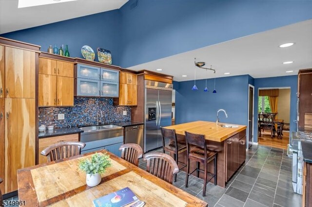 1056 Buxton Rd, Bridgewater Twp, NJ 08807 - kitchen with appliances with stainless steel finishes, a sink, a center island with sink, backsplash, and recessed lighting