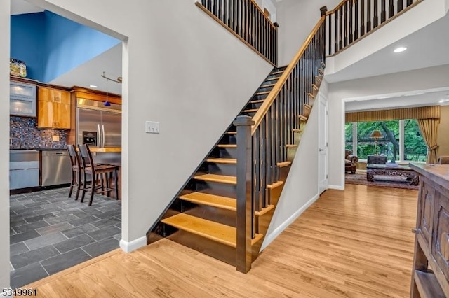 1056 Buxton Rd, Bridgewater Twp, NJ 08807 - stairs featuring baseboards, a high ceiling, recessed lighting, and wood finished floors