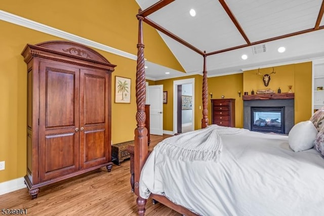 1056 Buxton Rd, Bridgewater Twp, NJ 08807 - bedroom featuring lofted ceiling, a glass covered fireplace, ornamental molding, light wood-style floors, and baseboards