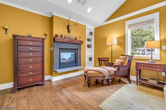 1056 Buxton Rd, Bridgewater Twp, NJ 08807 - sitting room featuring lofted ceiling, a glass covered fireplace, baseboards, built in features, and wood finished floors