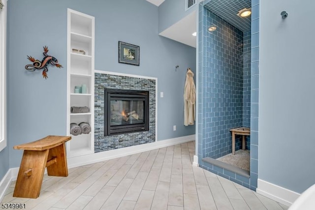 1056 Buxton Rd, Bridgewater Twp, NJ 08807 - living area with built in shelves, wood finished floors, baseboards, and a fireplace