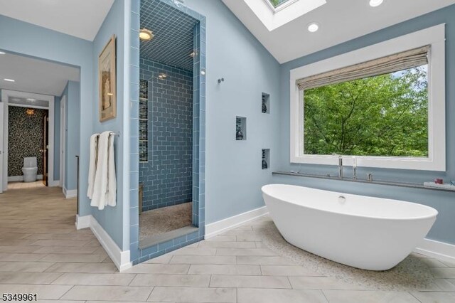 1056 Buxton Rd, Bridgewater Twp, NJ 08807 - full bathroom with a skylight, a tile shower, a freestanding tub, baseboards, and vaulted ceiling