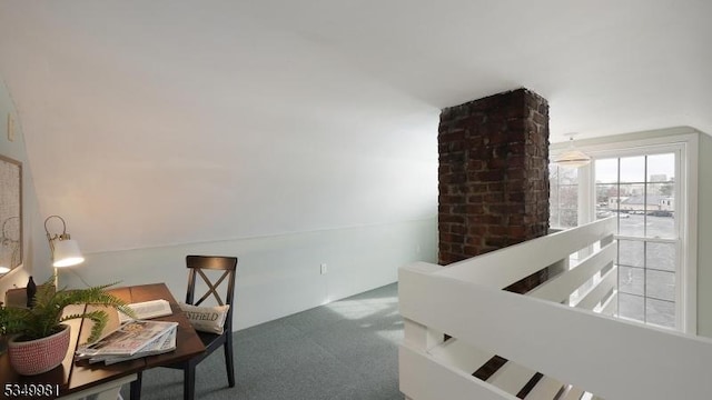 interior space featuring an upstairs landing and carpet