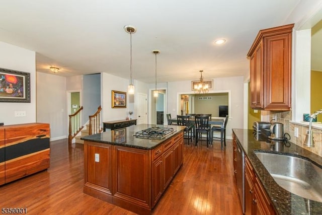 8 Marcin Way, Mount Olive Twp, NJ 07836 - kitchen with stainless steel appliances, a sink, dark wood-type flooring, brown cabinetry, and pendant lighting
