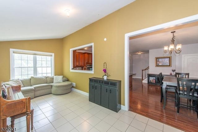 8 Marcin Way, Mount Olive Twp, NJ 07836 - living area featuring vaulted ceiling, a chandelier, light tile patterned flooring, and baseboards