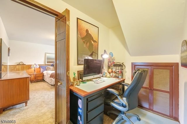 home office with light colored carpet and vaulted ceiling