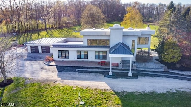 155 Route560, Sandyston Twp, NJ 07851 - rear view of house featuring stucco siding, a garage, and driveway