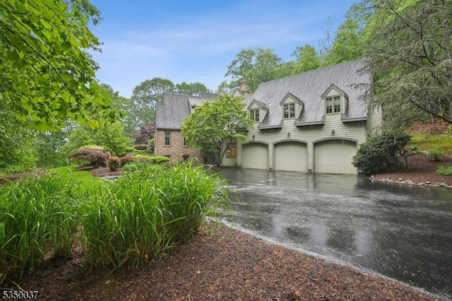 9 Valley View Dr, Lebanon Twp, NJ 07830 - cape cod home with an attached garage, asphalt driveway, a chimney, and a shingled roof