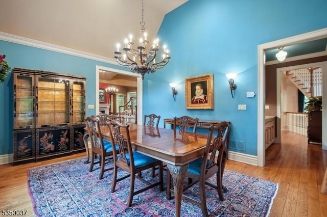 9 Valley View Dr, Lebanon Twp, NJ 07830 - dining area featuring a chandelier, wood finished floors, vaulted ceiling, crown molding, and baseboards