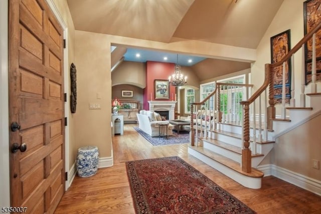 9 Valley View Dr, Lebanon Twp, NJ 07830 - foyer entrance with vaulted ceiling, baseboards, light wood-style floors, arched walkways, and a fireplace