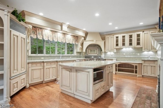 9 Valley View Dr, Lebanon Twp, NJ 07830 - kitchen featuring cream cabinetry, crown molding, tasteful backsplash, glass insert cabinets, and a kitchen island