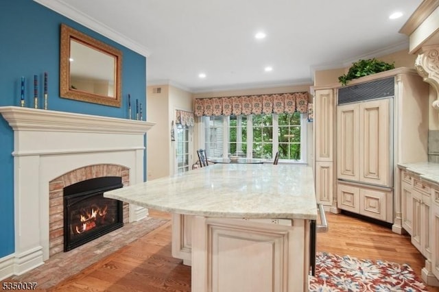 9 Valley View Dr, Lebanon Twp, NJ 07830 - kitchen featuring a fireplace, light wood-style floors, a center island, crown molding, and cream cabinetry