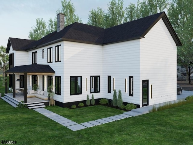 back of property with a yard and a chimney