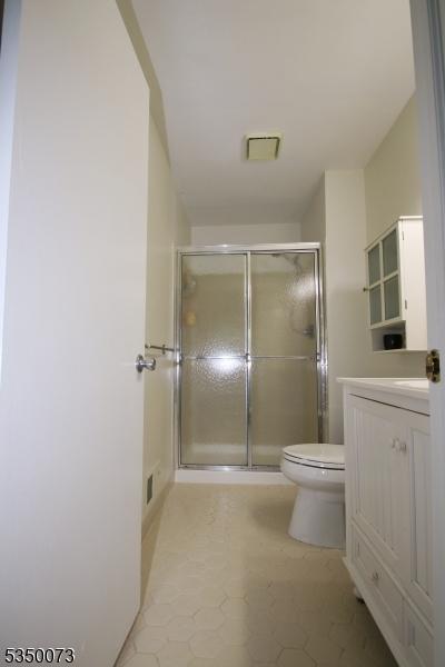 21 Crabapple Ln, Franklin Twp, NJ 08823 - full bath featuring toilet, vanity, a shower stall, and tile patterned flooring