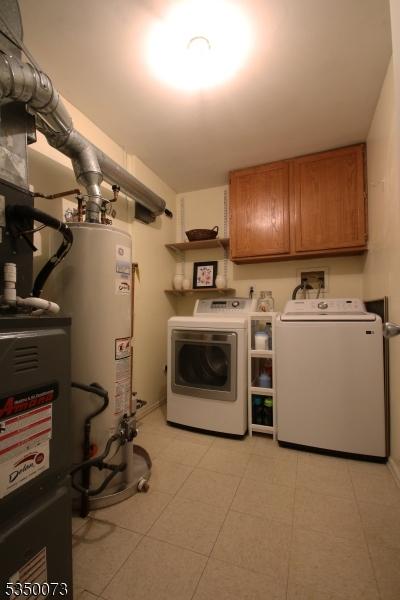 21 Crabapple Ln, Franklin Twp, NJ 08823 - laundry room featuring washing machine and dryer, cabinet space, and gas water heater