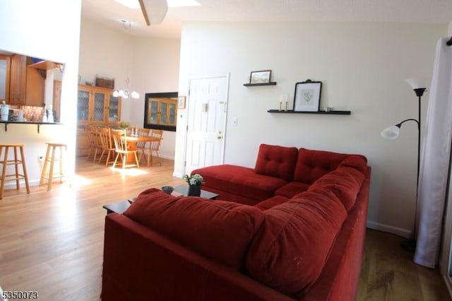 21 Crabapple Ln, Franklin Twp, NJ 08823 - living room featuring wood finished floors, a chandelier, lofted ceiling, baseboards, and a ceiling fan