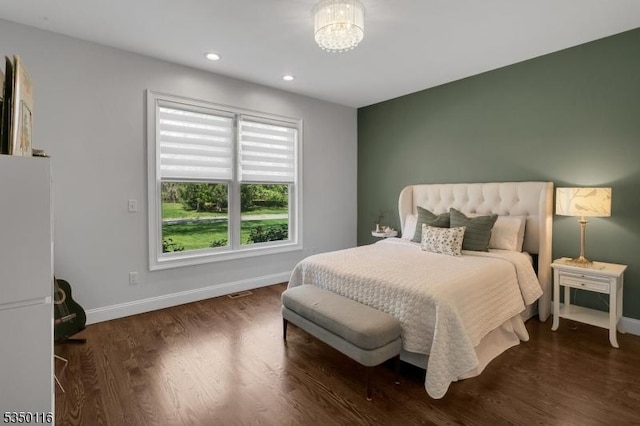 bedroom with recessed lighting, baseboards, an inviting chandelier, and wood finished floors