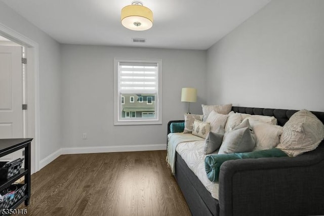 sitting room with baseboards, dark wood-style flooring, and visible vents