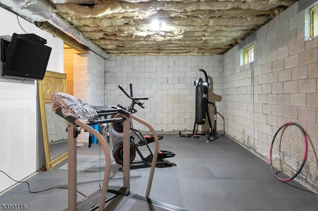 workout room featuring concrete block wall