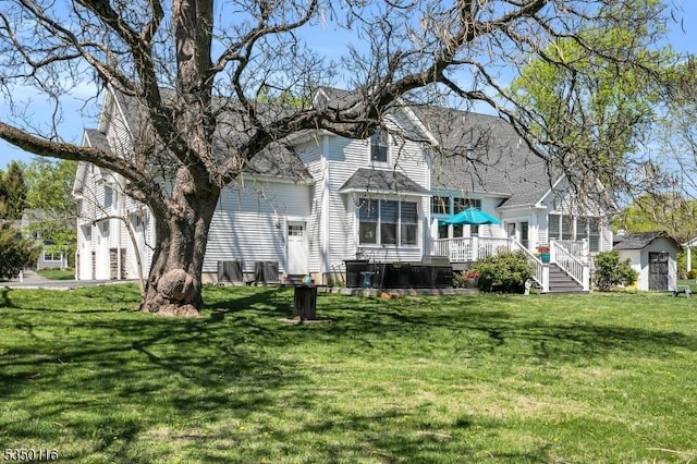back of house with a yard and a deck