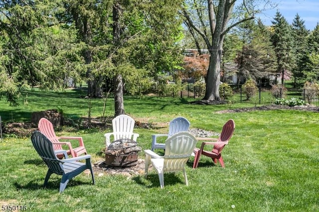 view of yard with a fire pit and fence