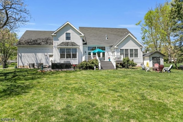 back of property featuring a storage unit, an outbuilding, a yard, and a deck