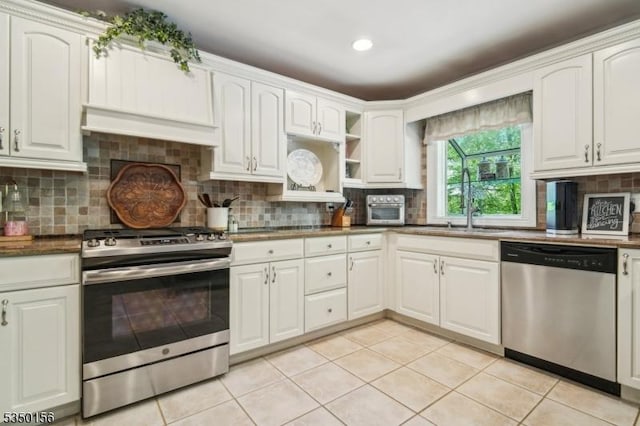 15 Longhill Rd, Randolph Twp, NJ 07869 - kitchen featuring appliances with stainless steel finishes, light tile patterned floors, decorative backsplash, open shelves, and white cabinetry