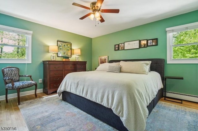 15 Longhill Rd, Randolph Twp, NJ 07869 - bedroom featuring wood finished floors, multiple windows, and a baseboard heating unit