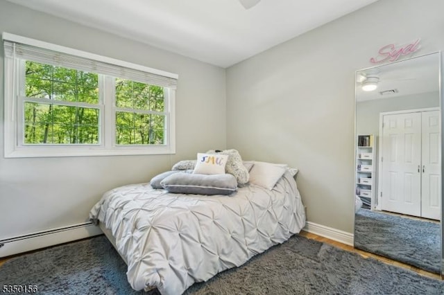 15 Longhill Rd, Randolph Twp, NJ 07869 - bedroom with multiple windows, a baseboard radiator, wood finished floors, and baseboards