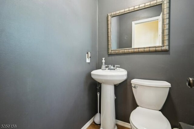 15 Longhill Rd, Randolph Twp, NJ 07869 - bathroom with toilet, a sink, and baseboards