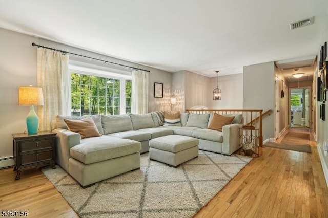 15 Longhill Rd, Randolph Twp, NJ 07869 - living area with light wood-type flooring, plenty of natural light, a baseboard radiator, and baseboards