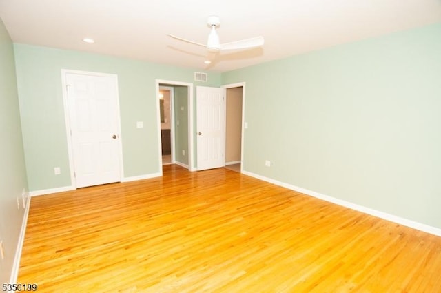 unfurnished bedroom featuring baseboards, light wood-type flooring, and visible vents