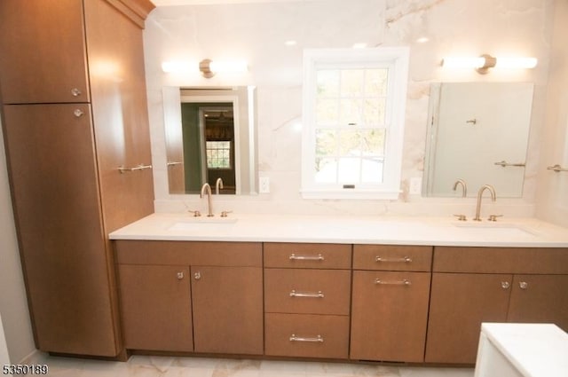 bathroom with double vanity and a sink